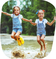 two girls smiling and jumping together