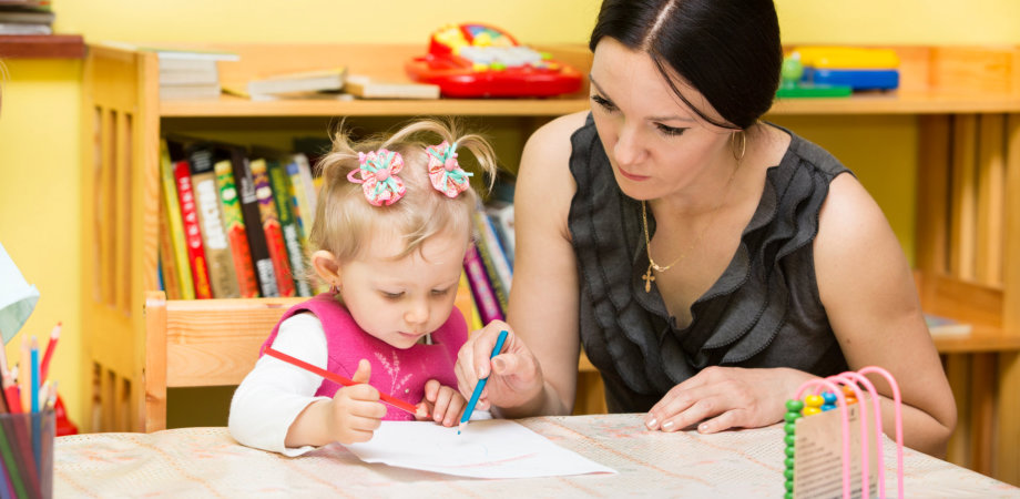 woman teaching the little girl